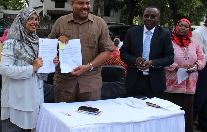 Dr. Hashina Begum, Acting Country Representative UNFPA Tanzania with Hon. Mahmoud Thabit Kombo Health Minister in Zanzibar.. showing the signed handing over agreement